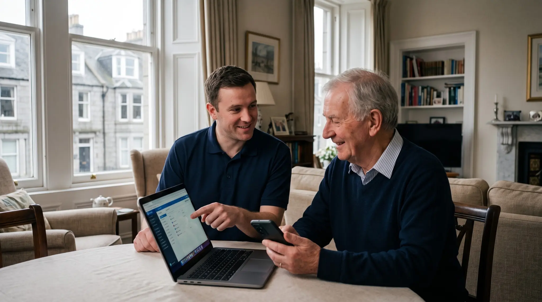 Engineer helping a customer set up a new laptop at home in Aberdeen